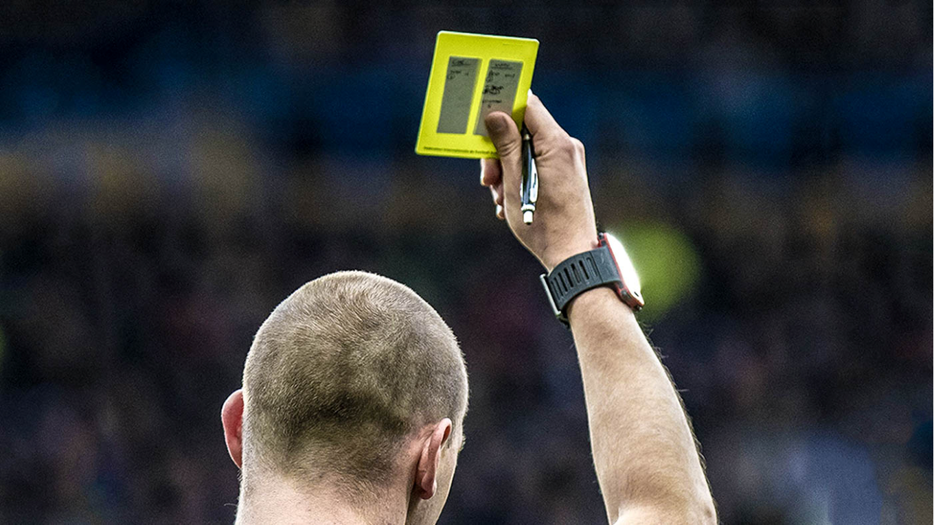 referee showing a yellow card