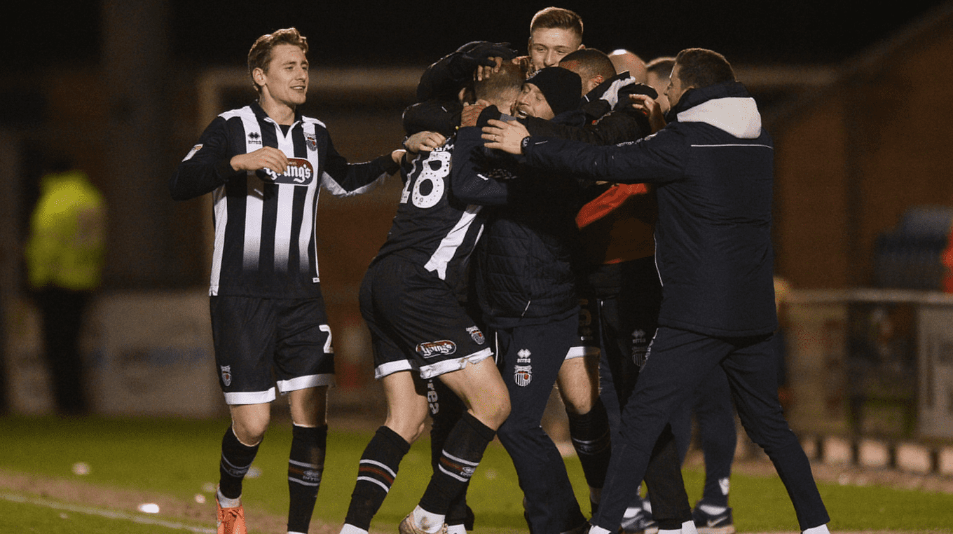 Grimsby Town players and staff celebrate Charles Vernam's goal v Colchester United.png
