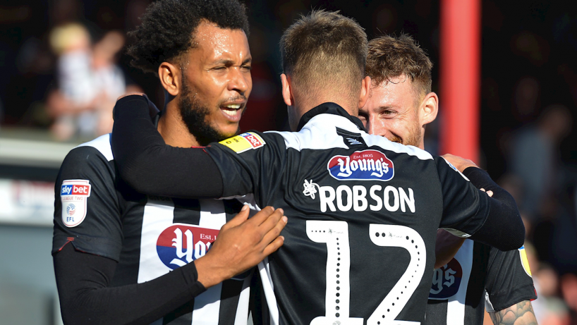 Grimsby town players celebrating a goal