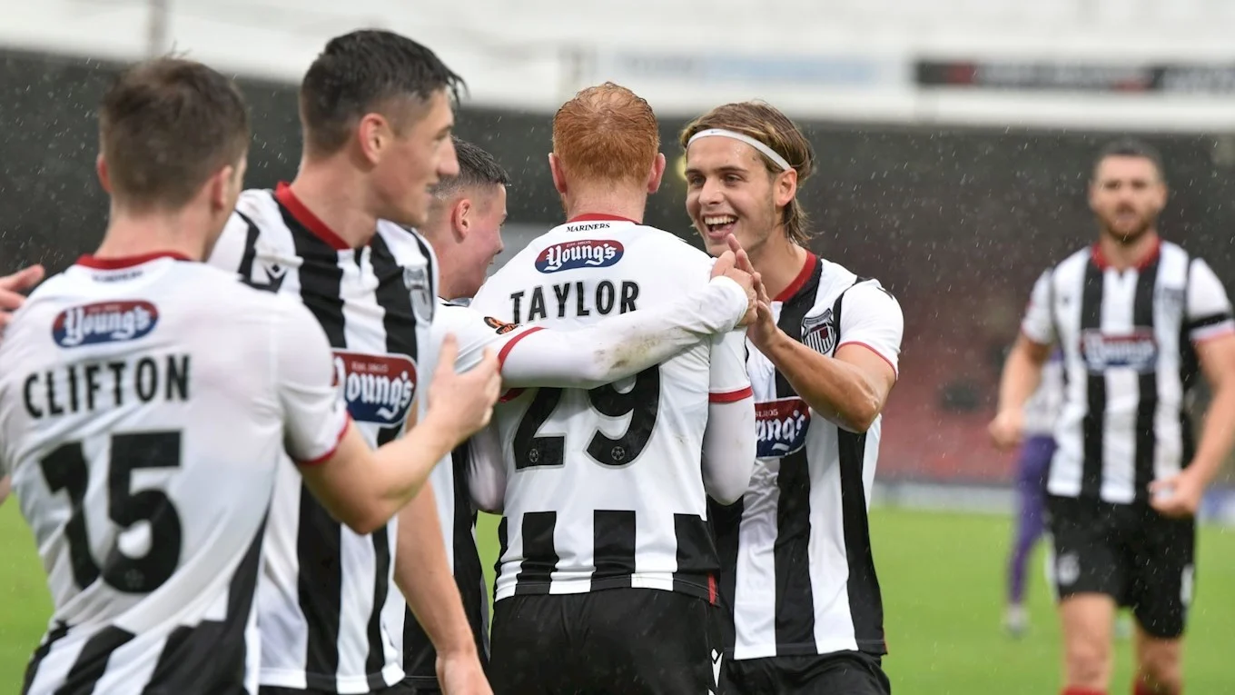Team congratulate Ryan Taylor after scoring against Dover
