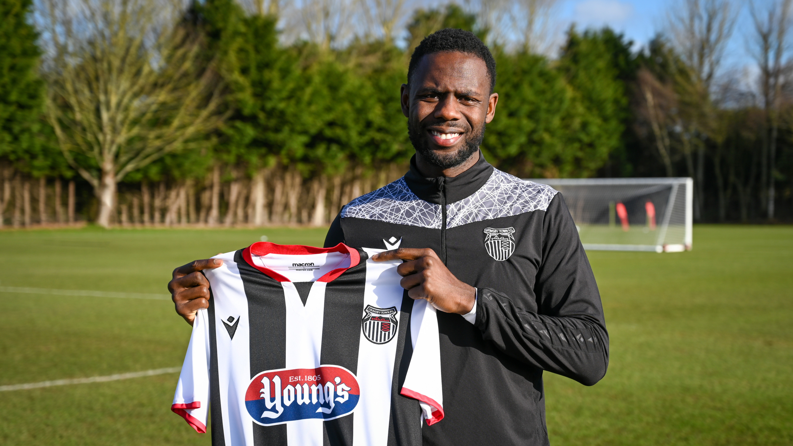 Emmanuel Dieseruvwe holding a GTFC shirt after signing for the club