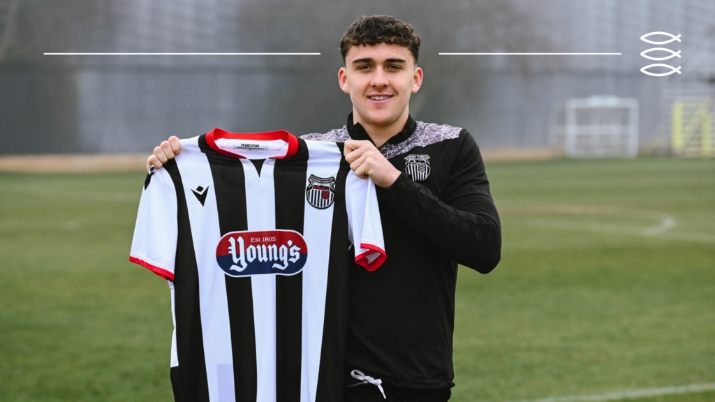 Callum Jones holding a GTFC home shirt after signing
