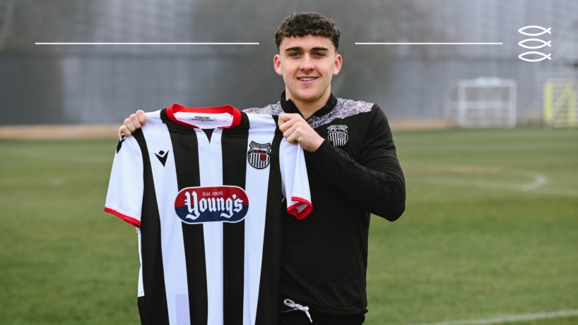Callum Jones holding a GTFC home shirt after signing