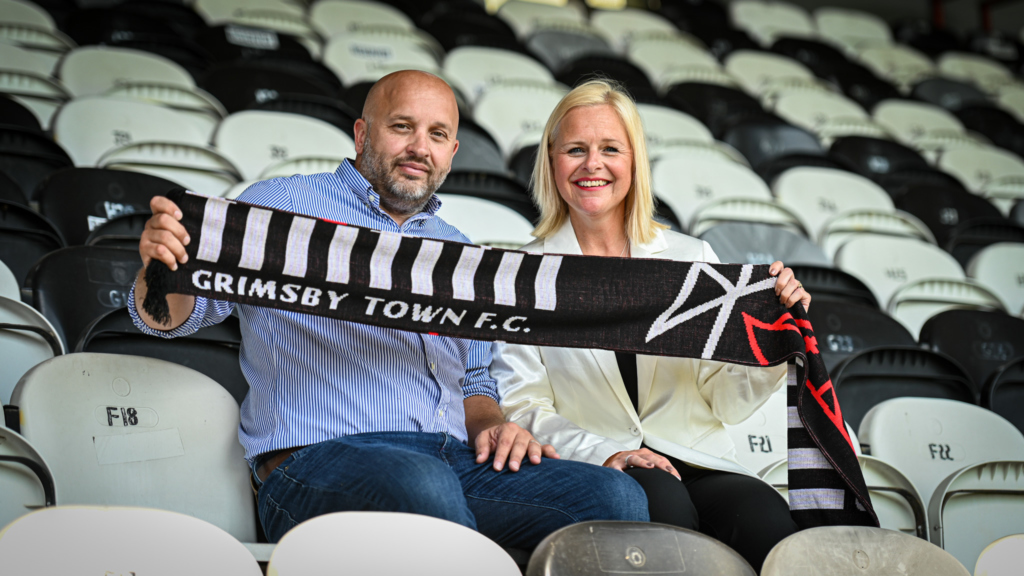 Debbie Cook and Matt Stinson holding GTFC Flag