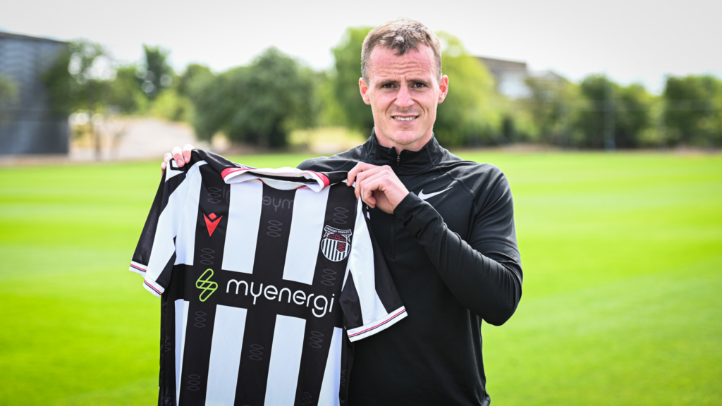 Kieran Green holds up a new GTFC home shirt