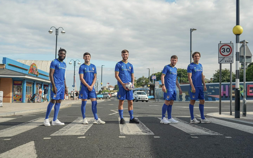 Grimsby Town Footballers posing down the seafront in new away kit
