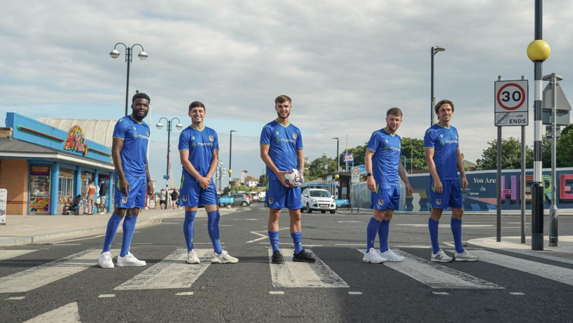 Grimsby Town Footballers posing down the seafront in new away kit