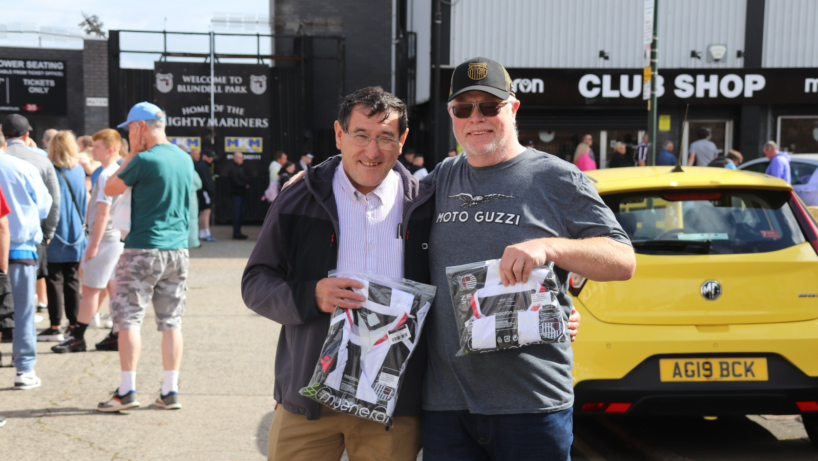 Two GTFC fans holding up their new Home jersey