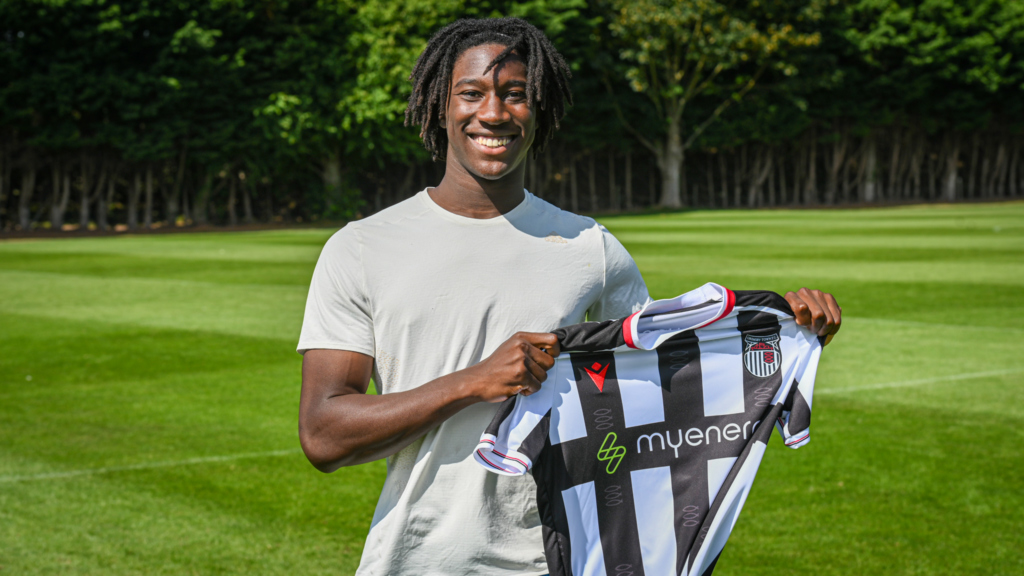 Aribim Pepple holding a GTFC shirt