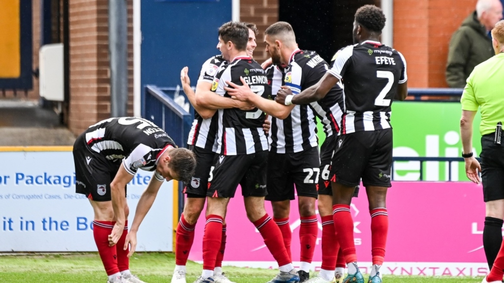 Players celebrate scoring at Stockport