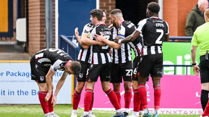 Players celebrate scoring at Stockport