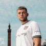 Sam Signs!